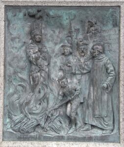 "Agnes Prest burnt upon Southernhay AD 1557". 1909 bronze relief sculpted panel by Harry Hems showing the burning at the stake of the Protestant martyr Agnes Prest in 1557, on the base of the Protestant Martyrs' Monument, Denmark Road, Exeter, Devon.